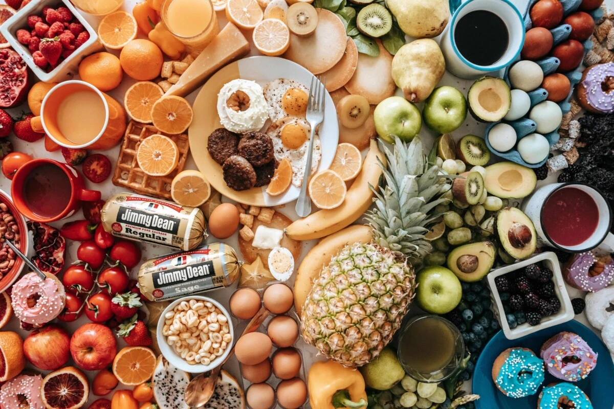 a top down view of lots of fruits, vegetables and eggs on a table